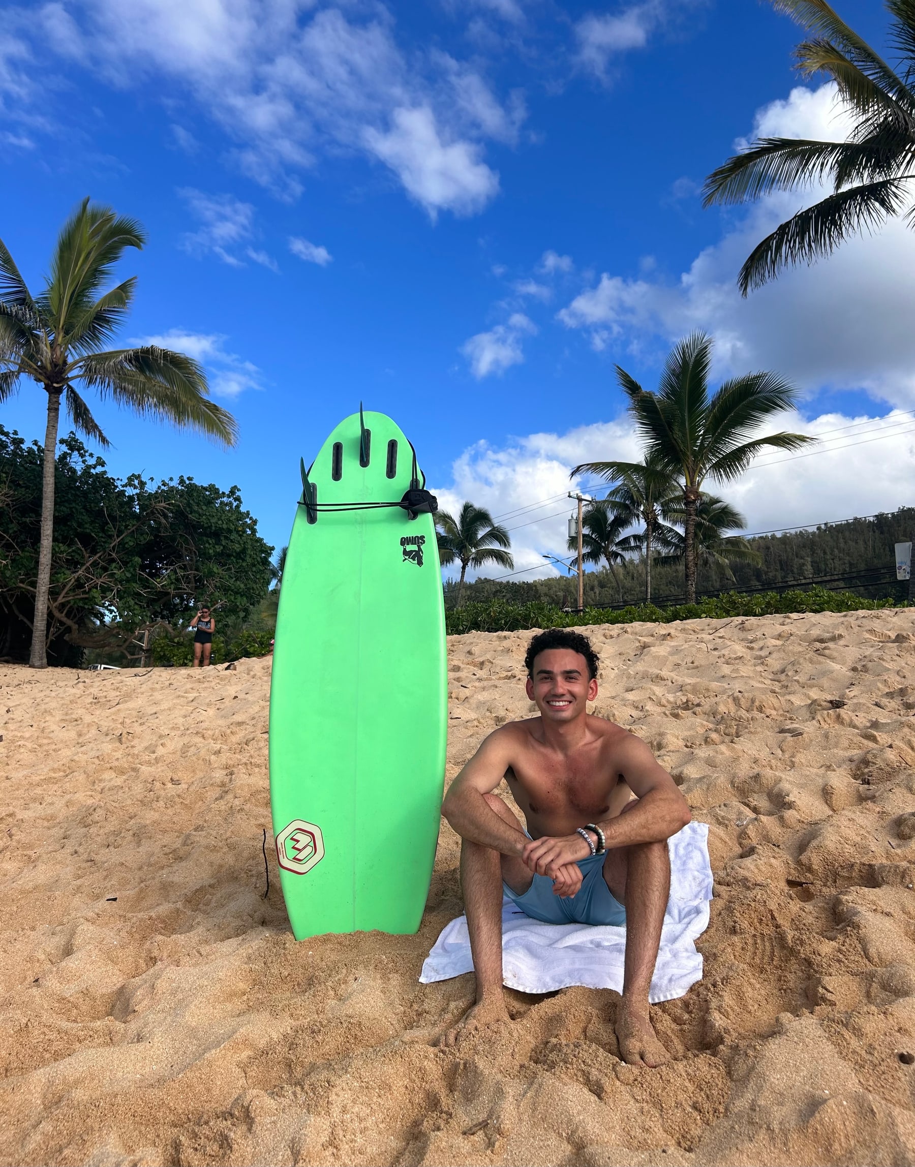 Stephen Leakos with a rescue board on a Hawaii beach